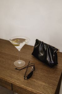 Kaboompics - Martini Cocktail with Green Olives and Black Clutch