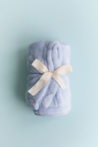 Soft Pastel Blankets And Fabric Bows On Minimal Background