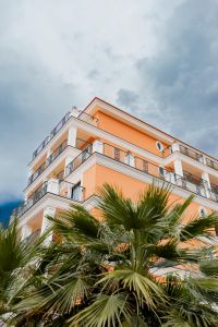 Kaboompics - Peach Italian Hotel Building With Balconies And Palm Trees