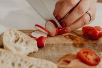 Kaboompics - Fresh Radish Slices on a Wooden Cutting Board