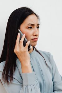 Kaboompics - Concerned Asian Woman During a Smartphone Call in Close-Up