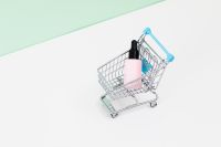 Kaboompics - Mini Metal Shopping Basket with Beauty Products on Mint Green Background