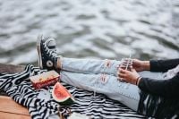 Kaboompics - Blonde woman having a healthy snack at the wooden pier