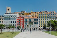 Kaboompics - Colorful Lisbon Facades and Bell Tower Across a Sunny City Square