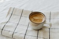 Kaboompics - Coffee Cup on a White and Black Checkered Blanket