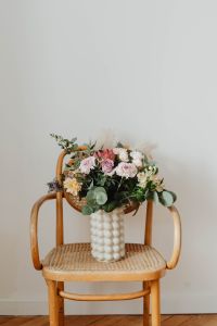 Kaboompics - Full-Frame Rattan Chair with a Pastel Flower Vase