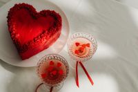 Kaboompics - Overhead Valentine Table Setting with Heart Cake and Red Drinks