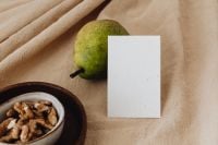 Kaboompics - Close-Up Pear and Blank Business Card with Walnuts on Linen