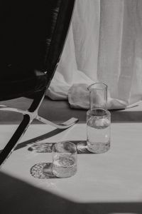 Kaboompics - Water Pitcher and Glasses in a High-Contrast Interior Still Life