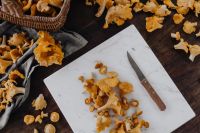 Kaboompics - Chanterelle Mushrooms On Cutting Board With Knife
