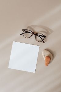 Kaboompics - Angled Blank Card Mockup with Glasses and Natural Stones