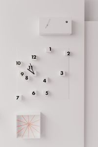 Minimalist Modern Wall Clock Design with 3D Floating Numbers on White Wall