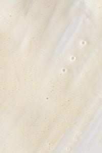 Kaboompics - Minimal Off-White Skincare Cream Texture with Fine Bubbles and Copy Space