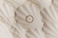 Kaboompics - Gold Chain Ring on White Flour with Soft Shadows