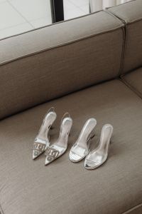 Kaboompics - Clear Heeled Sandals on a Textured Gray Sofa