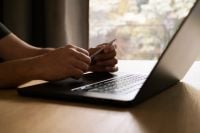 Kaboompics - Faceless Man Working on a Laptop by a Window