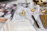 Kaboompics - Open Year Planner With Pen, Glasses And Gold Phone Case