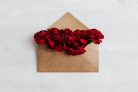 Kaboompics - Minimal Red Carnation Envelope Flat Lay with Copy Space
