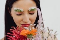 Kaboompics - Asian Woman Holding Orange Gerbera Bouquet with Floral Eyebrow Makeup, Eyes Closed