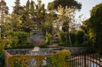 Kaboompics - Stone Sphere Garden Ornament Behind a Wrought-Iron Gate