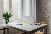 Kaboompics - Scandinavian Home Workspace by Window with Laptop, Tulips and Orange Juice