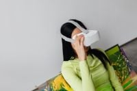 Kaboompics - Young Asian Woman Wearing VR Goggles in Neon Fashion