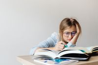 Kaboompics - Close Up of Student Studying Open Textbook