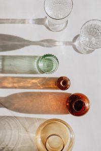 Kaboompics - Flat Lay of Clear and Colored Glassware with Long Shadows
