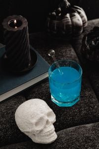 Kaboompics - Blue Halloween Drink and White Skull Still Life