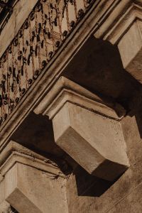 Kaboompics - Aged Limestone Bracket with Decorative Metal Railing Detail