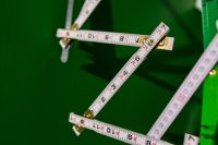 Kaboompics - Extandable wooden ruler on a green background