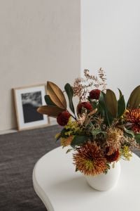 Kaboompics - A vase of flowers on a white coffee table
