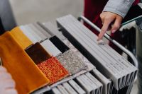 Kaboompics - Hand Selecting Upholstery Swatches in a Furniture Design Sample Book