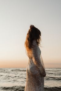 Kaboompics - Faceless Woman in Sequin Dress by the Ocean at Golden Hour
