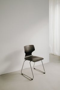 Kaboompics - Dark Sculptural Chair by Sheer Curtains