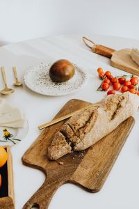 Kaboompics - Cherry Tomatoes and Rustic Bread on a Wooden Board