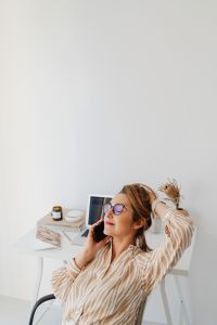 Kaboompics - Woman Talking on Phone with Wall Clock and Copy Space
