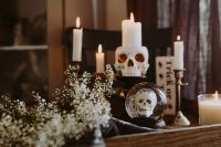 Kaboompics - Halloween Candle Display with Skull Candle, Crystal Skull and Flowers