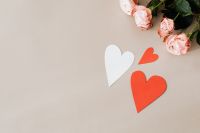 Kaboompics - Pink Roses and Red and White Paper Hearts on Beige