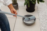 Kaboompics - Close-Up of Rinsing a Mop in a Metal Bowl