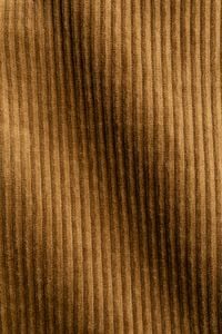 Kaboompics - Camel Corduroy Fabric Texture with Ribbed Wale and Draped Fold, Neutral Brown Textile Background for Fashion