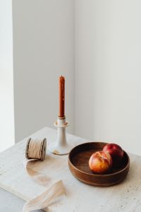 Kaboompics - White Candle and Peaches in Wooden Bowl, Minimal Copy Space
