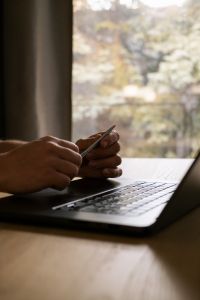 Kaboompics - Faceless Man Working on a Laptop Beside a Window
