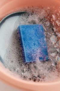 Kaboompics - Overhead View of a Blue Sponge in Soapy Water
