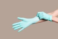 Kaboompics - Hands Pulling on a Turquoise Medical Glove, Healthcare Hygiene and Safety Training