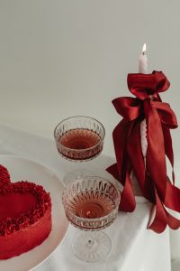 Kaboompics - Red Bow Candle with Dried Flowers and Pink Cocktails