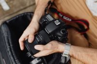 Kaboompics - Photographer holding a DSLR camera