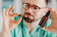 Kaboompics - Doctor Using Pipette Above Amber Bottle