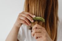 Kaboompics - Jade Comb and Hands Detangling a Section of Hair