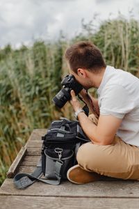 Kaboompics - Photographer holding a DSLR camera